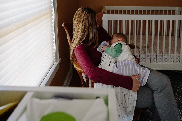 Mom rocks and nurses baby in nursery before a nap during a Sunday morning pancakes photo session