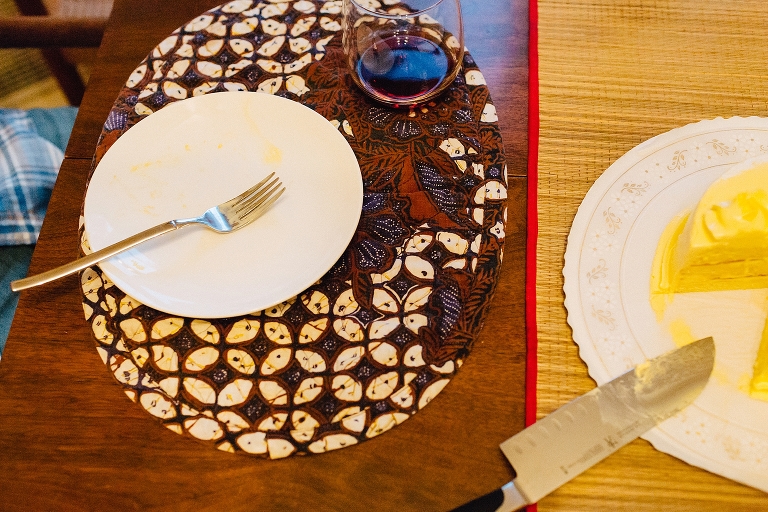 Place setting with wine glass and yellow cake