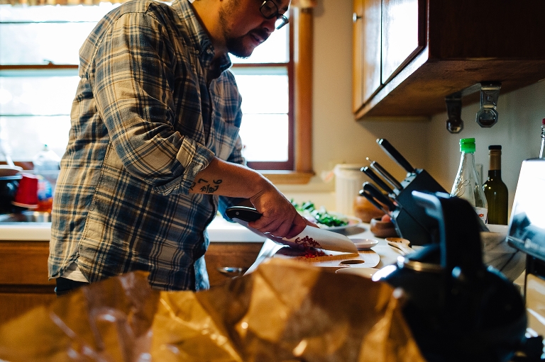 Man in kitchen cutting vegetables for dinner