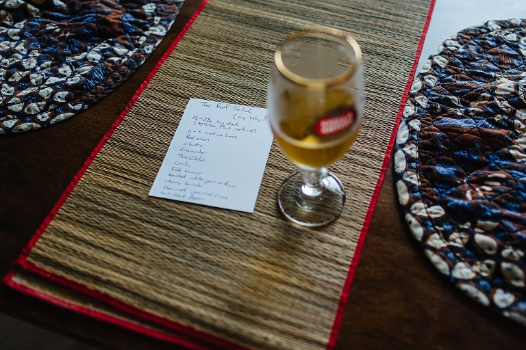 Place setting at dinner table with beef salad recipe and glass of beer.