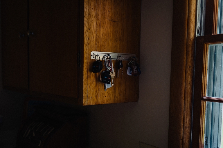 Car and house keys hanging on wood cabinet