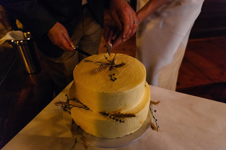 Bride and groom cut the wedding cake together
