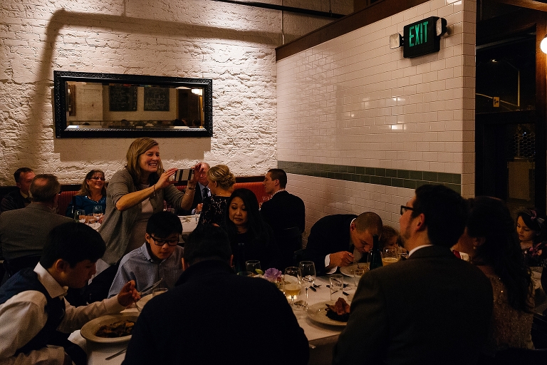 woman takes photos of dinner 