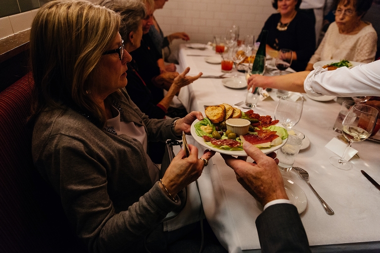 Family passes appetizers around at resturant