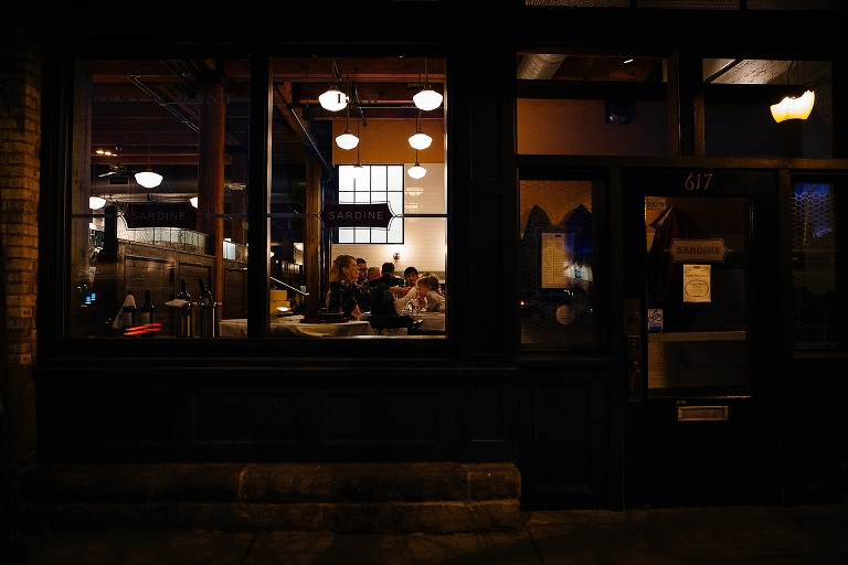 Family sits together at restaurant after wedding