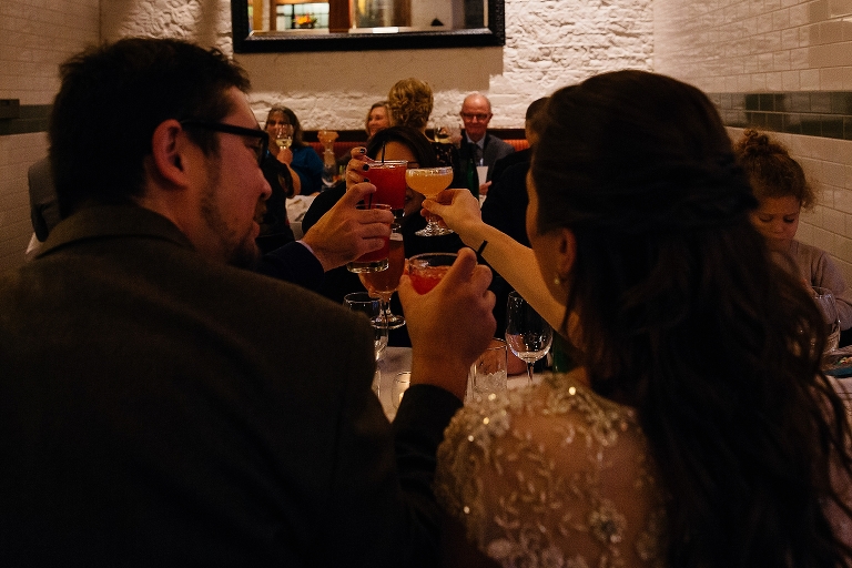 Family toast to the bride and groom at dinner