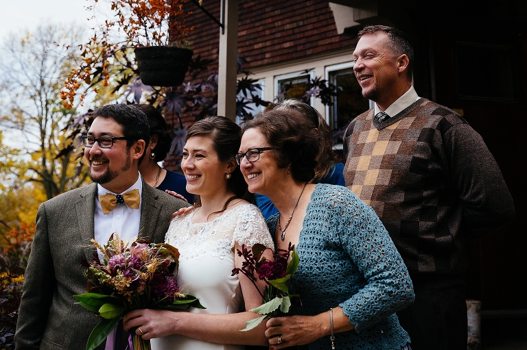 Bride and groom takes photos with the family after the wedding