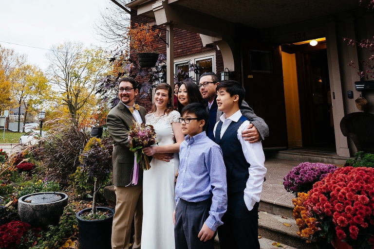Bride and groom takes photos with the family after the wedding