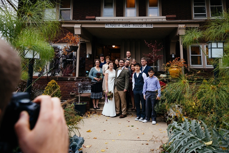 Bride and groom takes photos with the family after the wedding