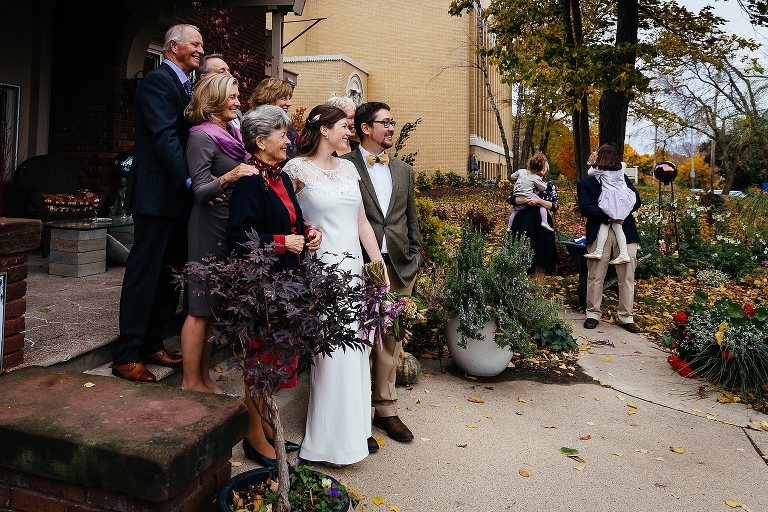 Bride and groom takes photos with the family after the wedding