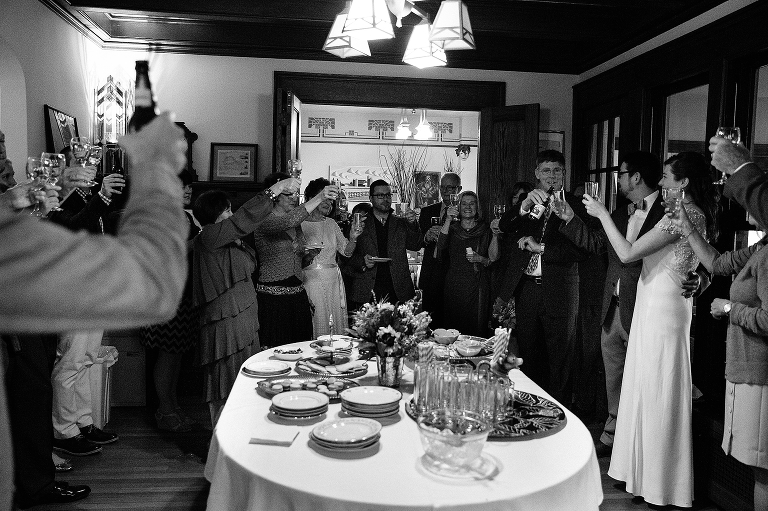Black and white. Family shares a toast after wedding