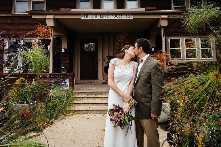 Bride and groom kiss outside venue after getting married
