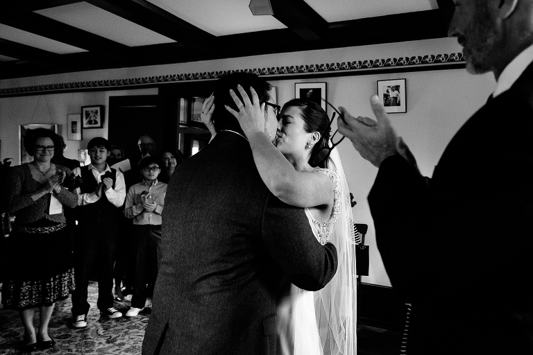 Black and white. Bride and groom kiss at wedding ceremony