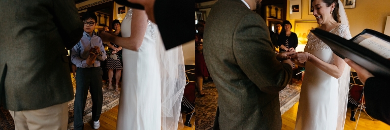 Bride and groom put each others rings on at wedding ceremony.