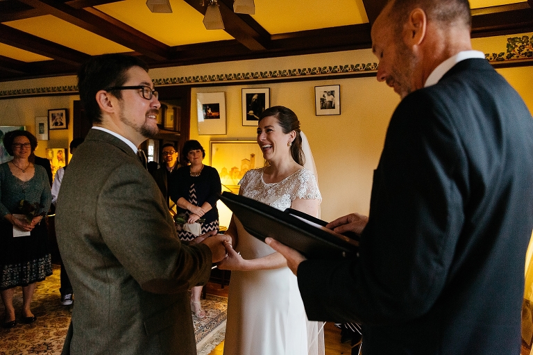 Bride and groom stand together getting married.