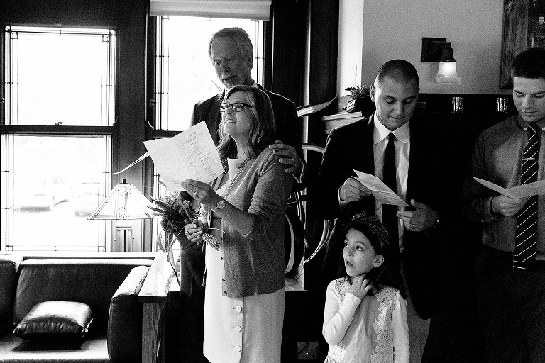 Black and white. Family sings together at wedding ceremony.