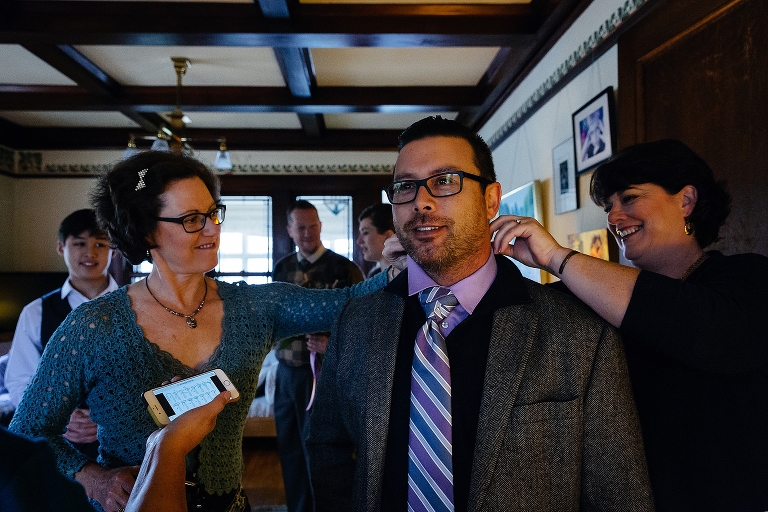 Family stands together getting ready for the wedding