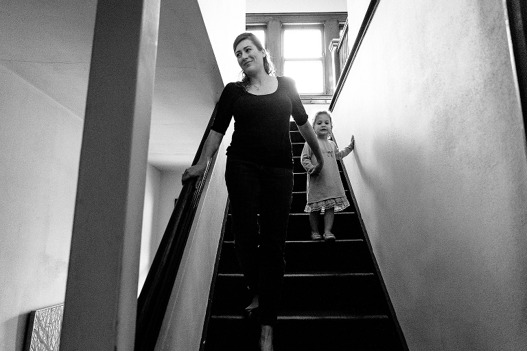 Black and white, Woman walks little girl down the stairs
