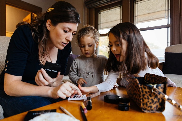 Two little girls help bride pick out makeup colors