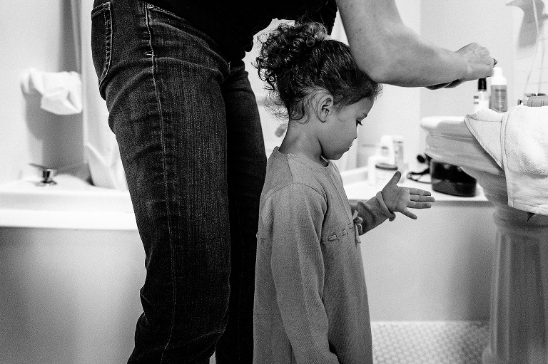Father helps get daughter ready for a wedding in the bathroom