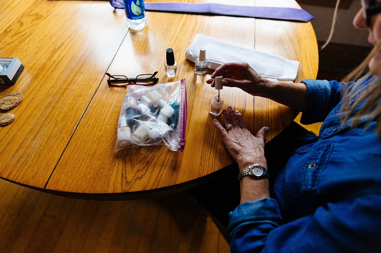 Woman putting on nail polish getting ready for a wedding