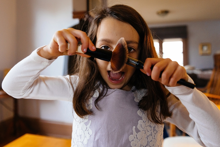 Child playing with makeup brushes