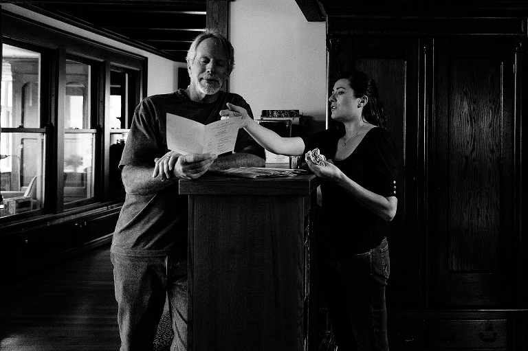 Black and white, two people looking at wedding program