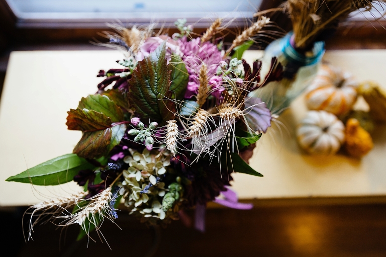 bouquet with green leaves, purple flowers, and wheat grass
