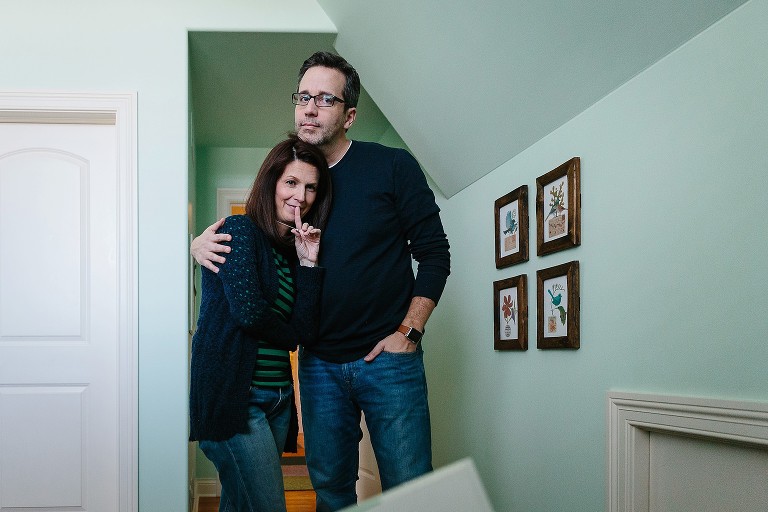 Mom and Dad watch their children read and snuggle 