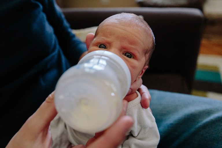 color of newborn getting a bottle 