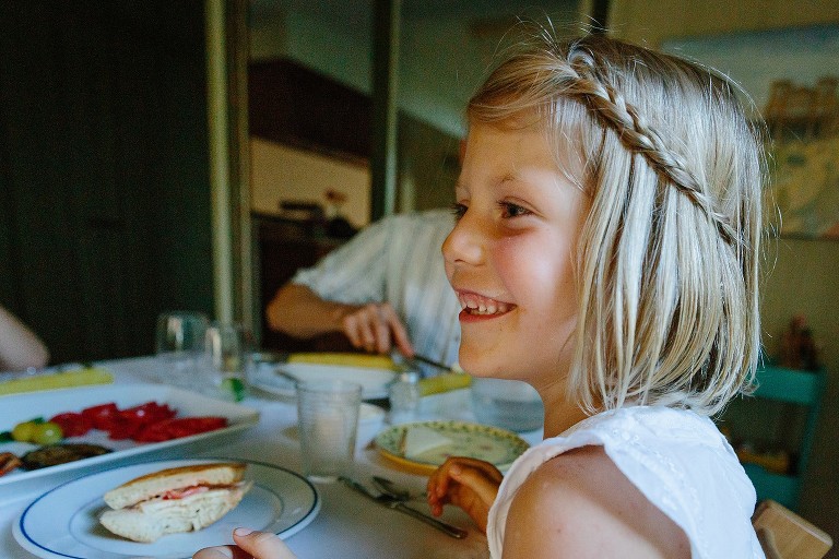 Portrait of a smiling girl at the dinner table. 