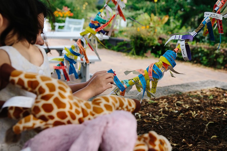 moms ties a wish around the wishing tree 