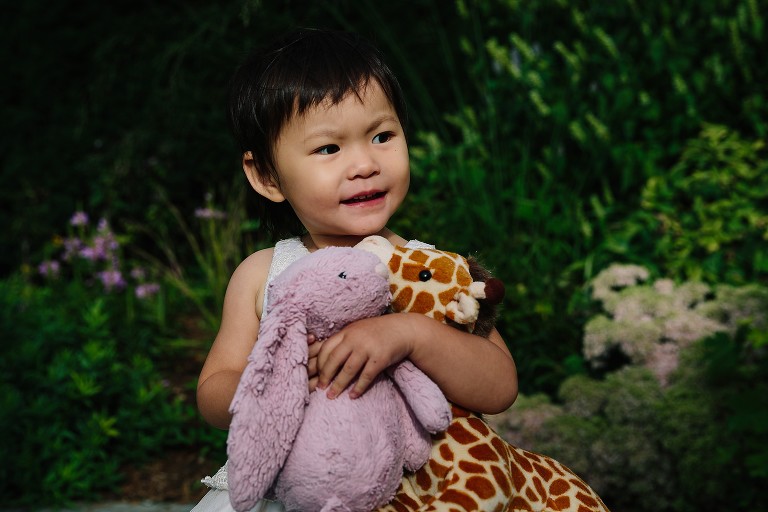 Daughter holds stuffed animals 