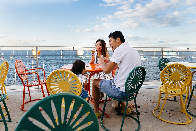 Family eats ice cream next to lake 