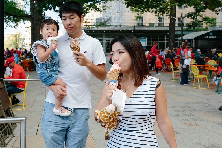 Family eats ice cream in crowded terrace 