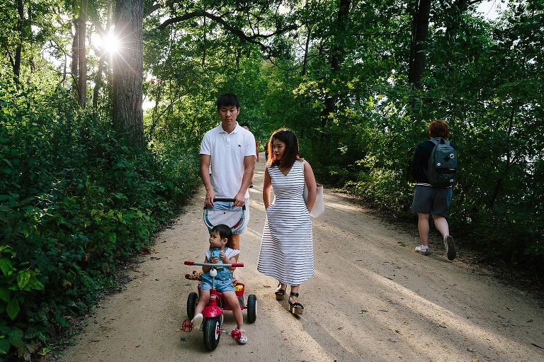 Family walk on busy bike path 