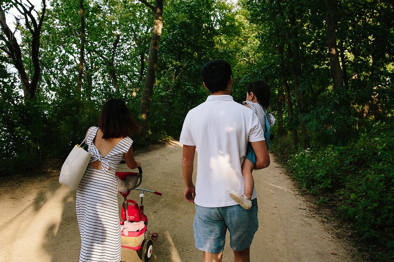 Family walks on busy bike path 