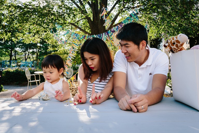 Mother holds up 2 fingers to help daughter count how hold she is