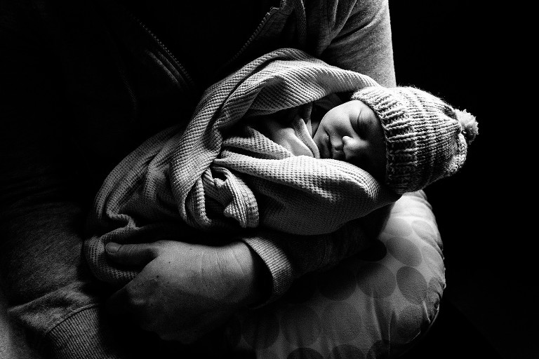 Newborn in hospital with window light. 