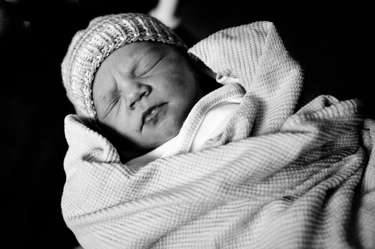 Black and white image of sleeping newborn girl. 