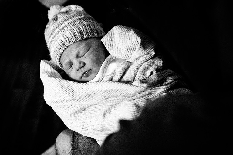Black and white image of sleeping newborn girl. 