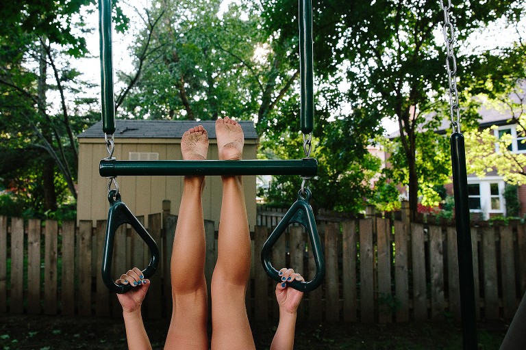 Upside down girl, just feet and hands. Feet dirty. 