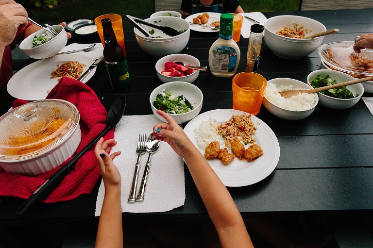 Dinner table filled with bowls of food and utensils.