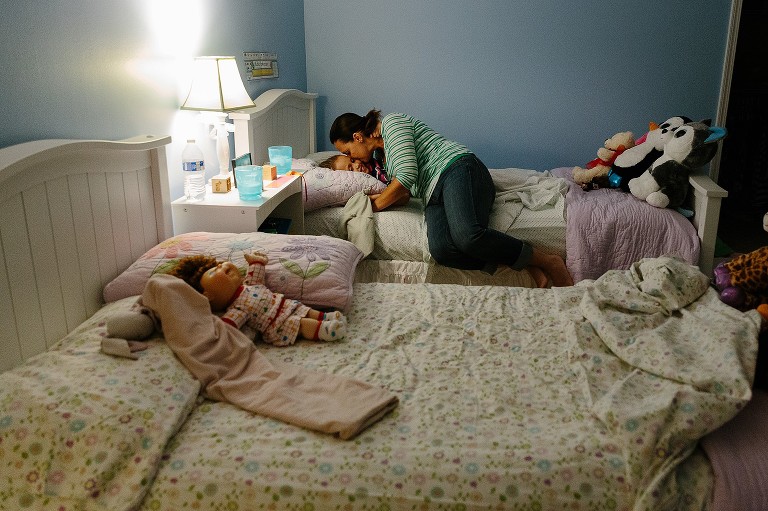 mom kisses 7 year old daughter good night