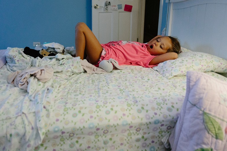 5 year old daughter wakes up in her bed.