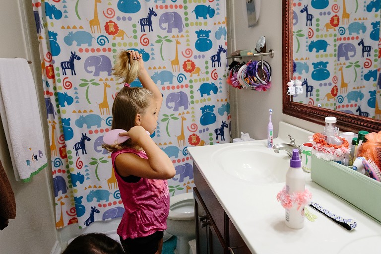7 year old bushes own hair as she gets ready for school 