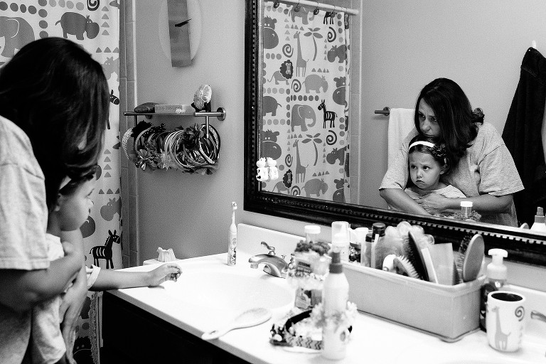 mom comforts young girl who is feeling nervous 