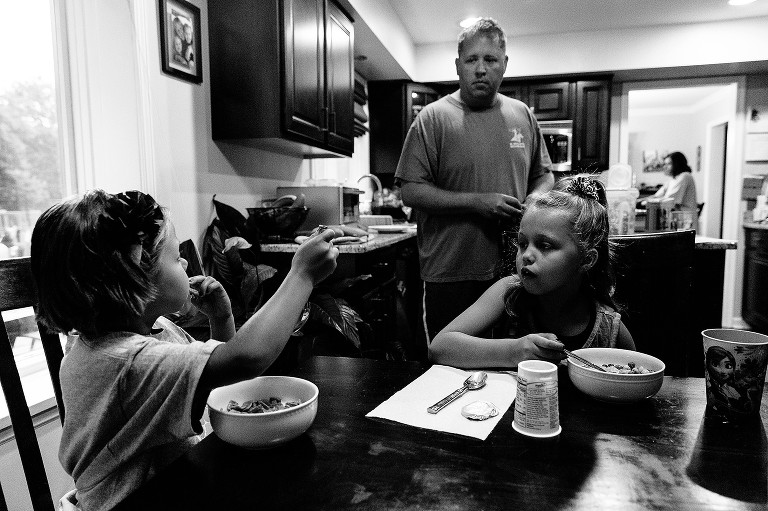 family gets ready for hte day wiht breakfast and backpacks 