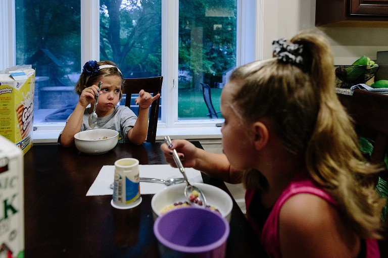 Girls eat breakfast before school 
