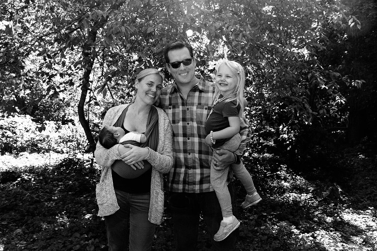 Black and white portrait of family of four. 